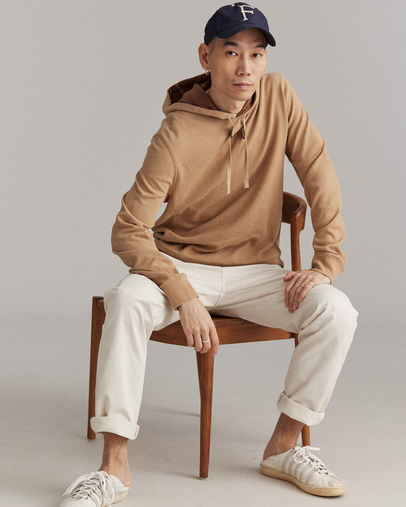 Male model wears the Rib Hoodie Pullover in Camel