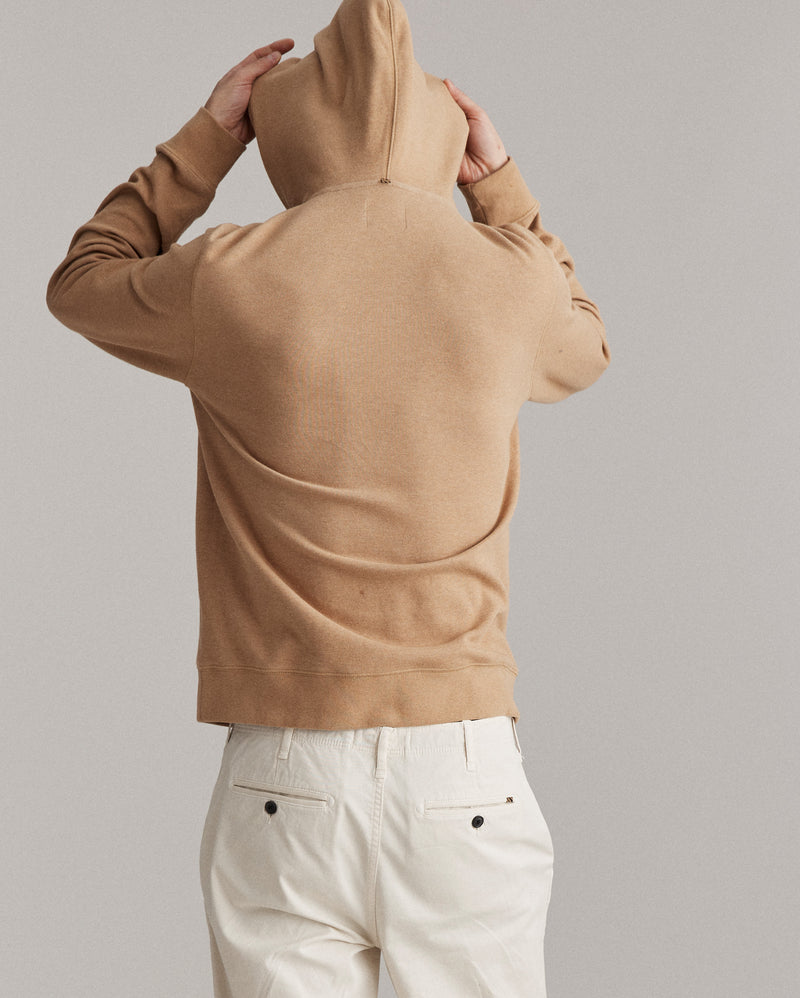 Male model shows the back of the hoodie.