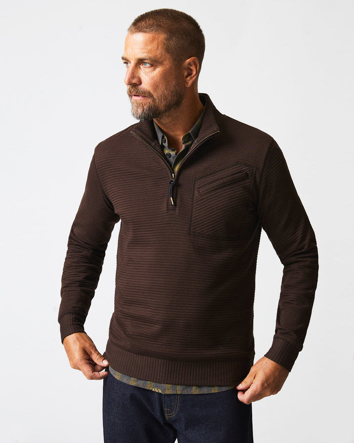 Male model wears the Quilted Half Zip in Chocolate