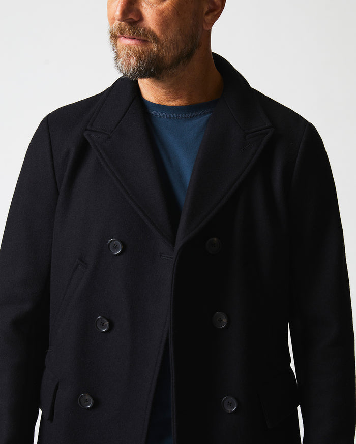 Male model wears the Bond Peacoat in Black