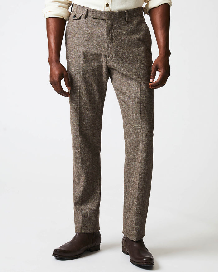 Male model wears the Flat Front Trouser in Black/Brown