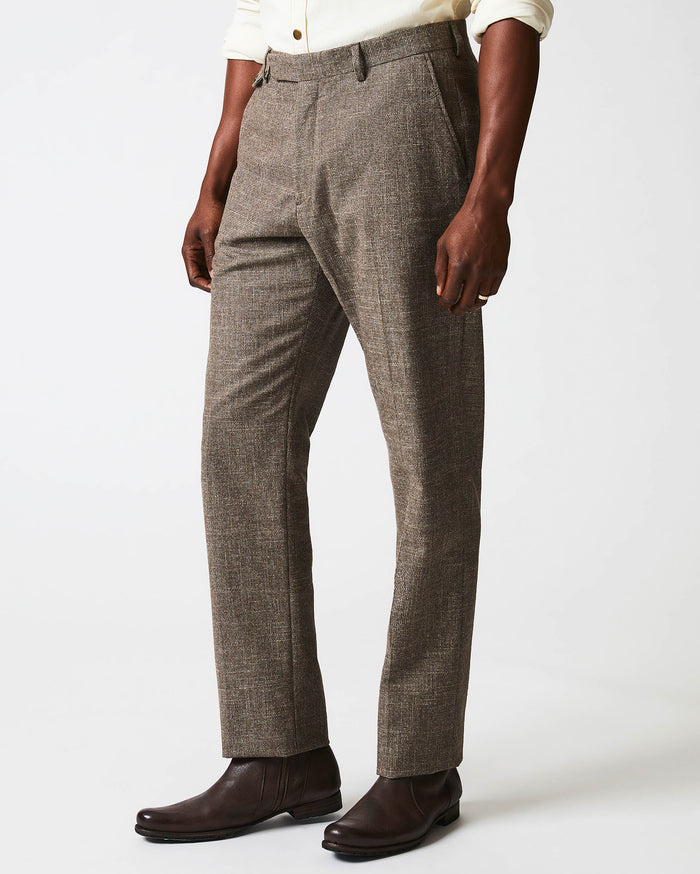 Male model wears the Flat Front Trouser in Black/Brown