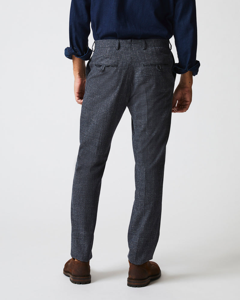 Male model wears the Flat Front Trouser in Charcoal