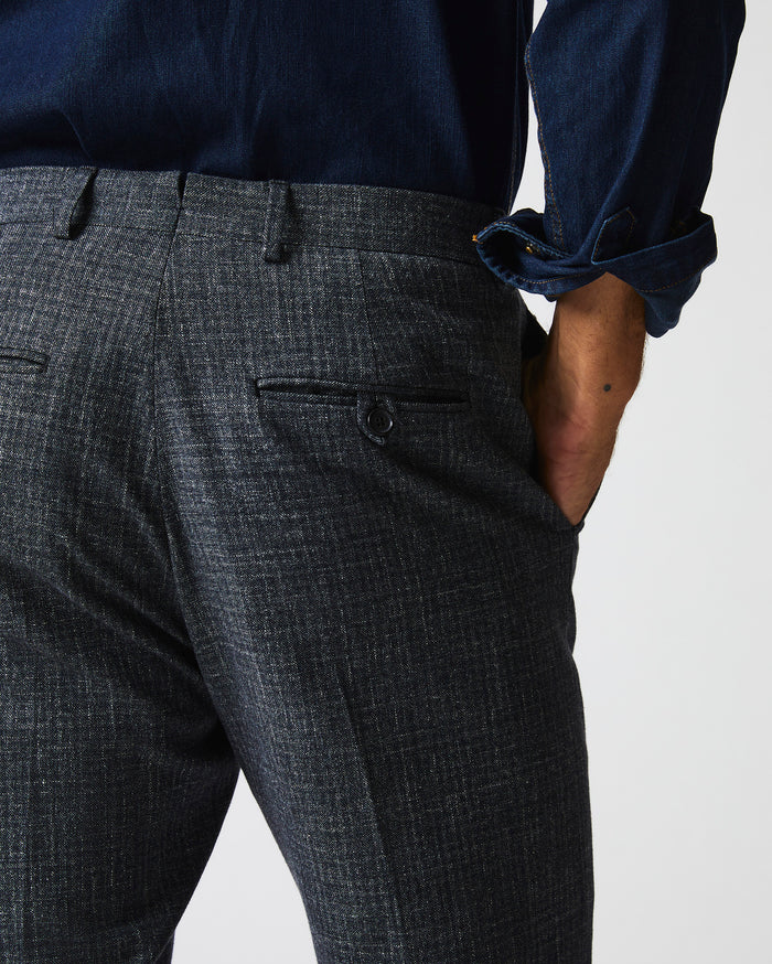 Male model wears the Flat Front Trouser in Charcoal