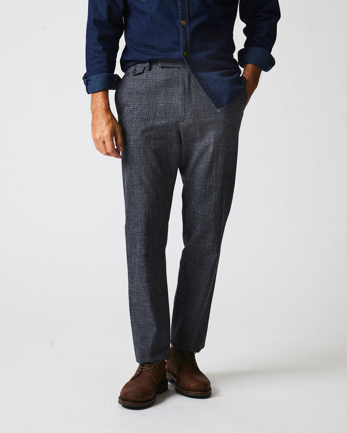 Male model wears the Flat Front Trouser in Charcoal