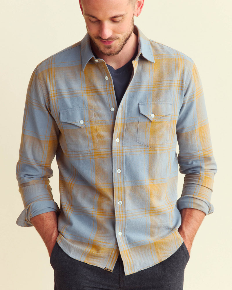 Male model wears the large scale plaid western shirt in faded denim