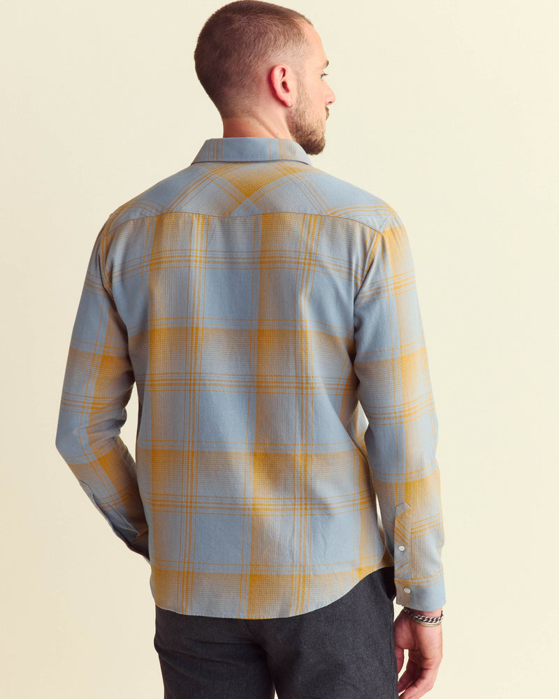 Male model wears the large scale plaid western shirt in faded denim